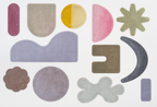 Set of colorful geometric rug shapes on a white background
