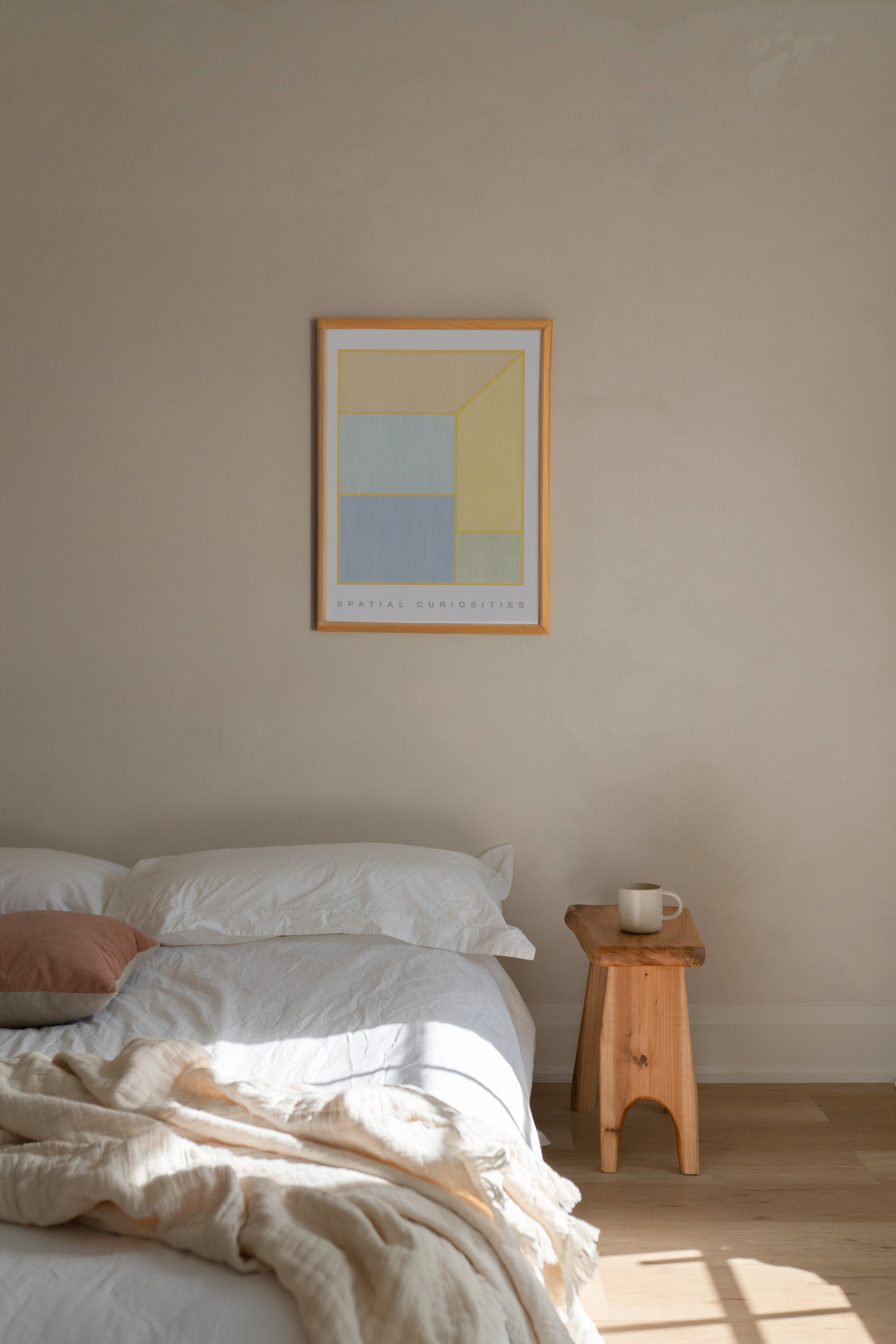 Bedroom with a bed, wooden side table, and abstract art on the wall.