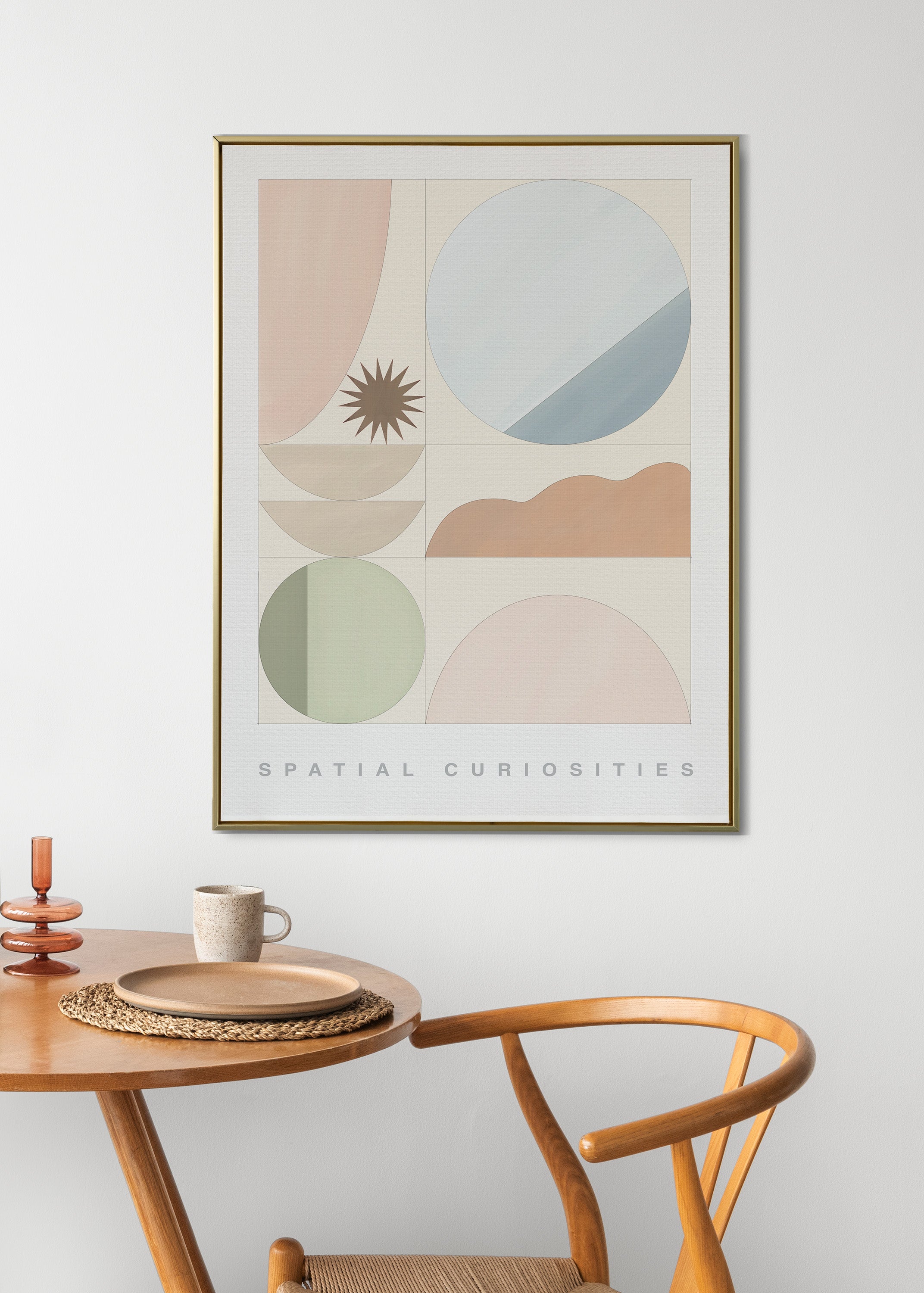 Framed abstract art print on a wall above a wooden table with a chair.