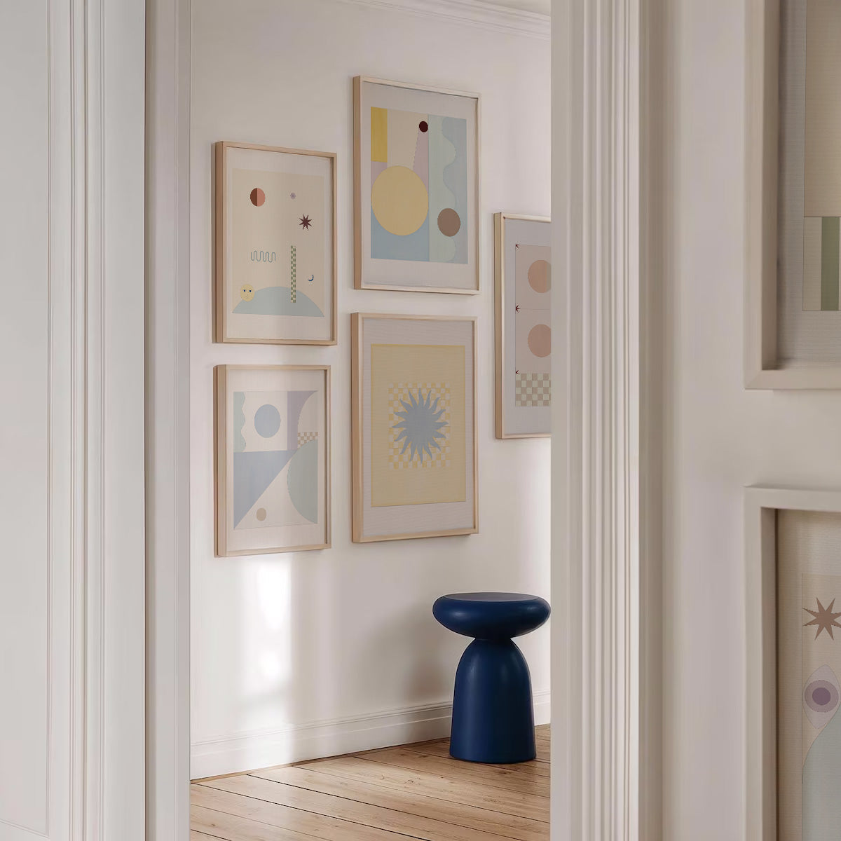 Modern interior with abstract art on the wall and a blue stool.