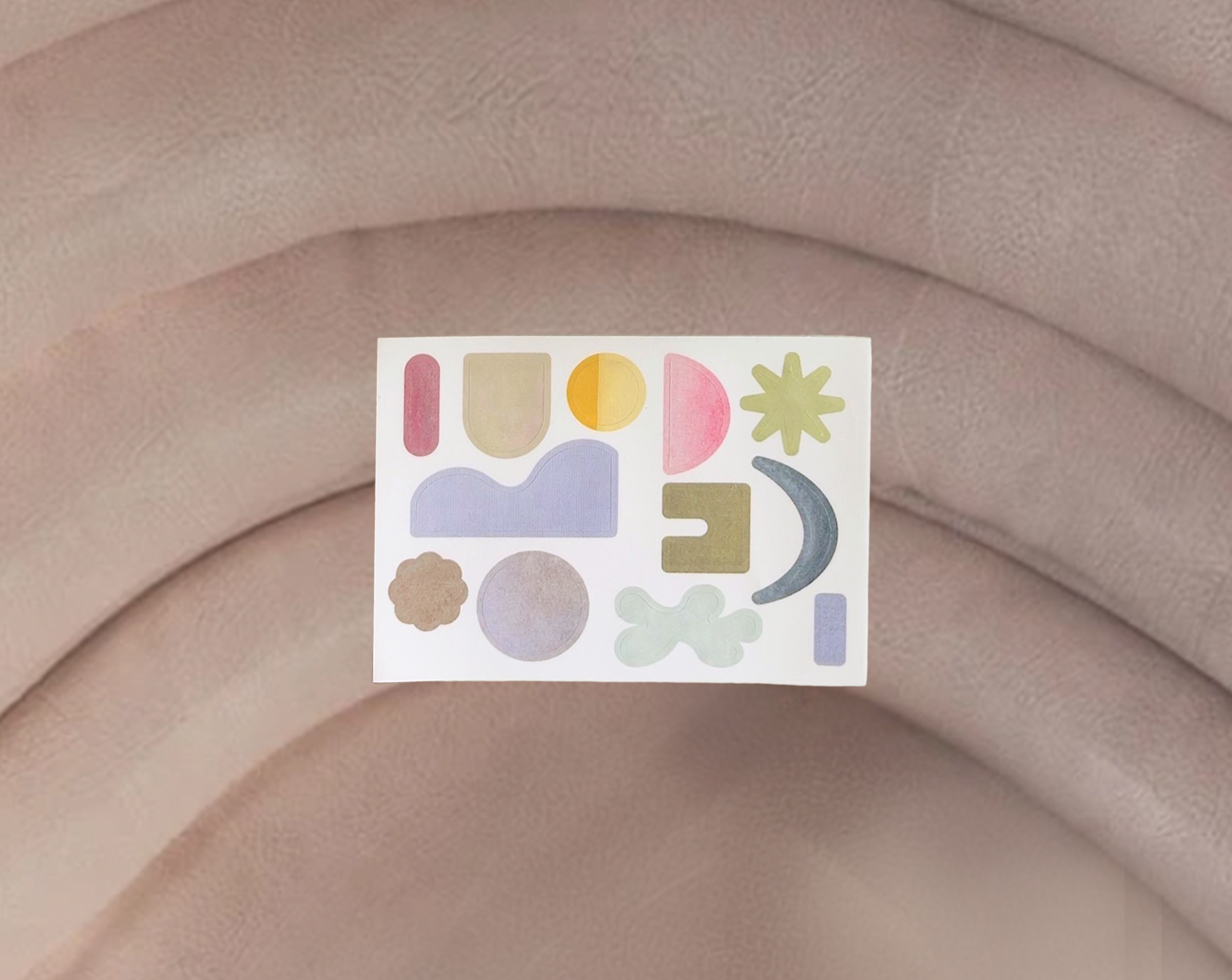 Colorful abstract sticker on a beige fabric background