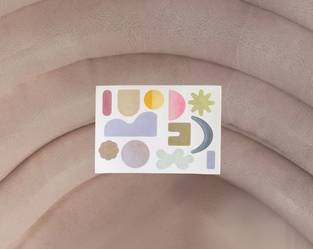 Colorful abstract sticker on a beige fabric background