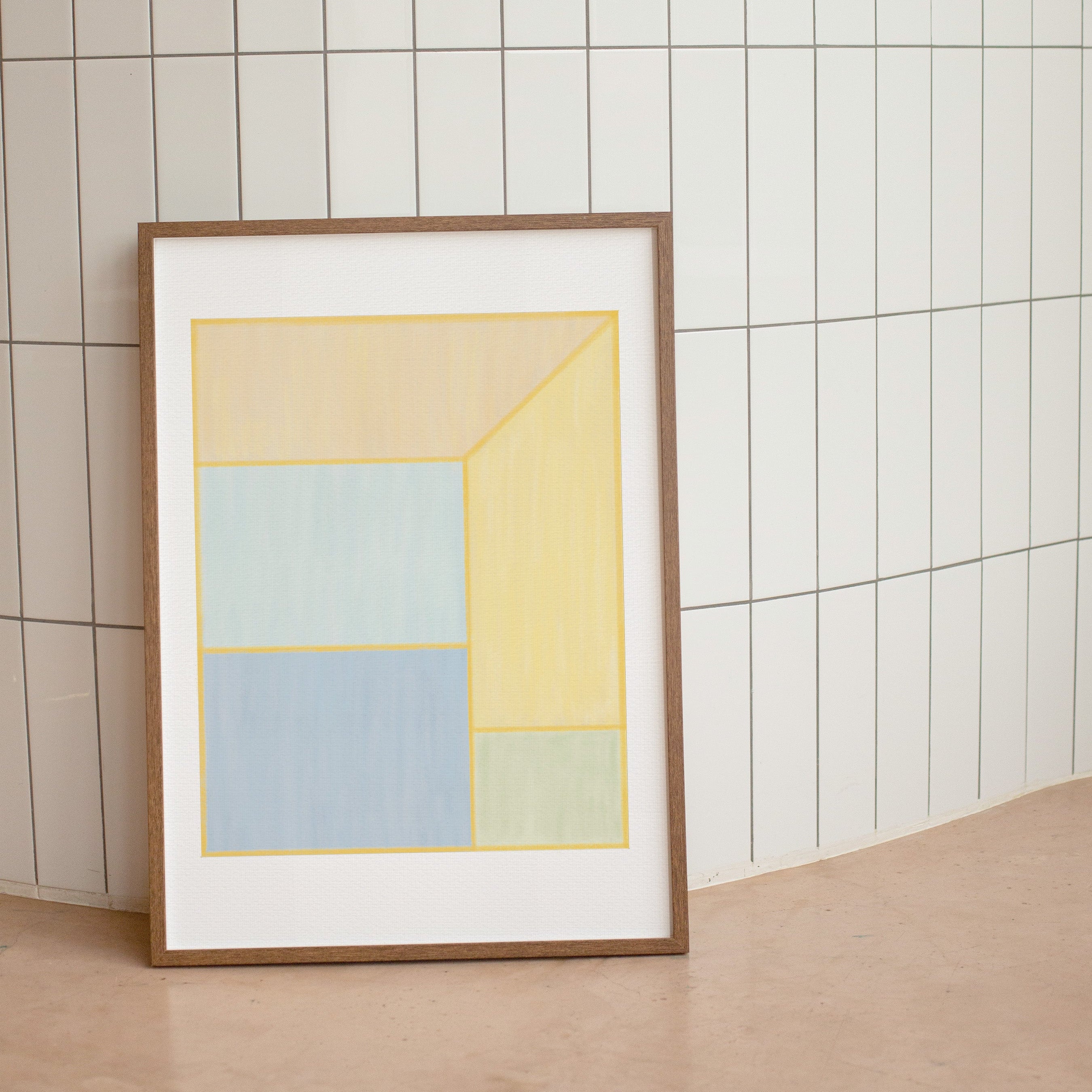 Framed abstract art print with geometric shapes on a tiled wall.